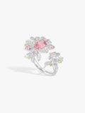 Strawberry ring with pink oval gemstone, diamond pavé floral clusters on white metal band