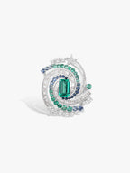 Silver-tone geometric ring with green center stone, blue side stones, oval halo