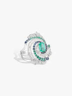 Silver-toned ring with green rectangular center stone, blue accents, sparkling pave halo