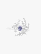 Silver meteor-style ring with gray-blue center stone and star diamond accents