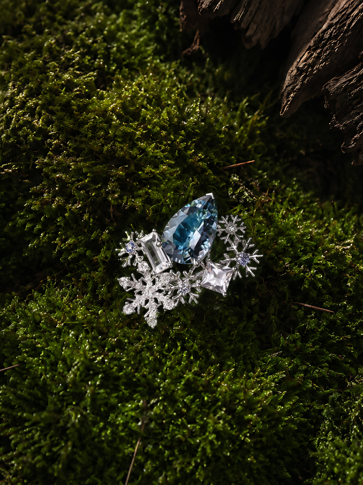 Aquamarine snowflake ring with oval blue gemstone and starburst snowflake halo settings