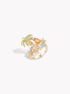 Gold-tone palm tree ring with orange oval stone and clear flower accents