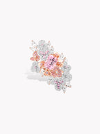 Floral cluster gemstone ring with pink center stone and clear pavé accents