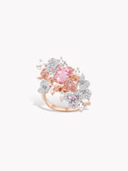 Floral pink gemstone ring with open-work metal band and sparkling round stones