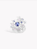 Rose garden ring, oval blue sapphire center with white diamond floral halo