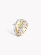 Twisted band ring with pale yellow-green oval stone and prong-set diamond-like details
