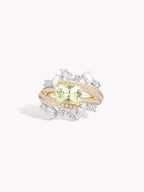 Twisted band ring with oval yellow-green gemstone and diamond-like accents, gold-tone