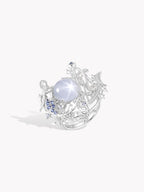Starlit Siren Harp ring with oval white cabochon, detailed silver harp and blue stones