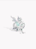 Silver-tone ring with light teal oval gemstone and sparkling snowflake cluster