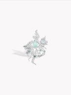 Silver-tone faerie ring with teal oval center stone and sparkling clear details