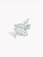 Silver-tone ring with teal oval gemstone and crystal snowflake accents