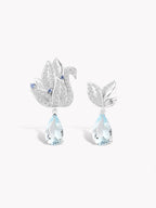 Silver swan earrings with blue teardrop aquamarine stones and crystal pavé detail