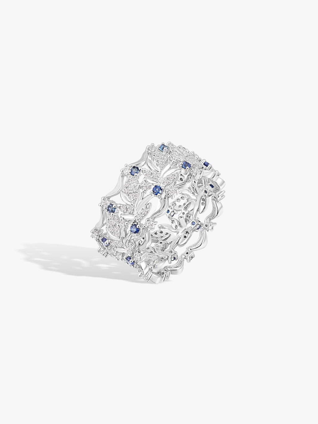 Ornate swan-wing ring with blue stones and white diamond accents in textured openwork setting