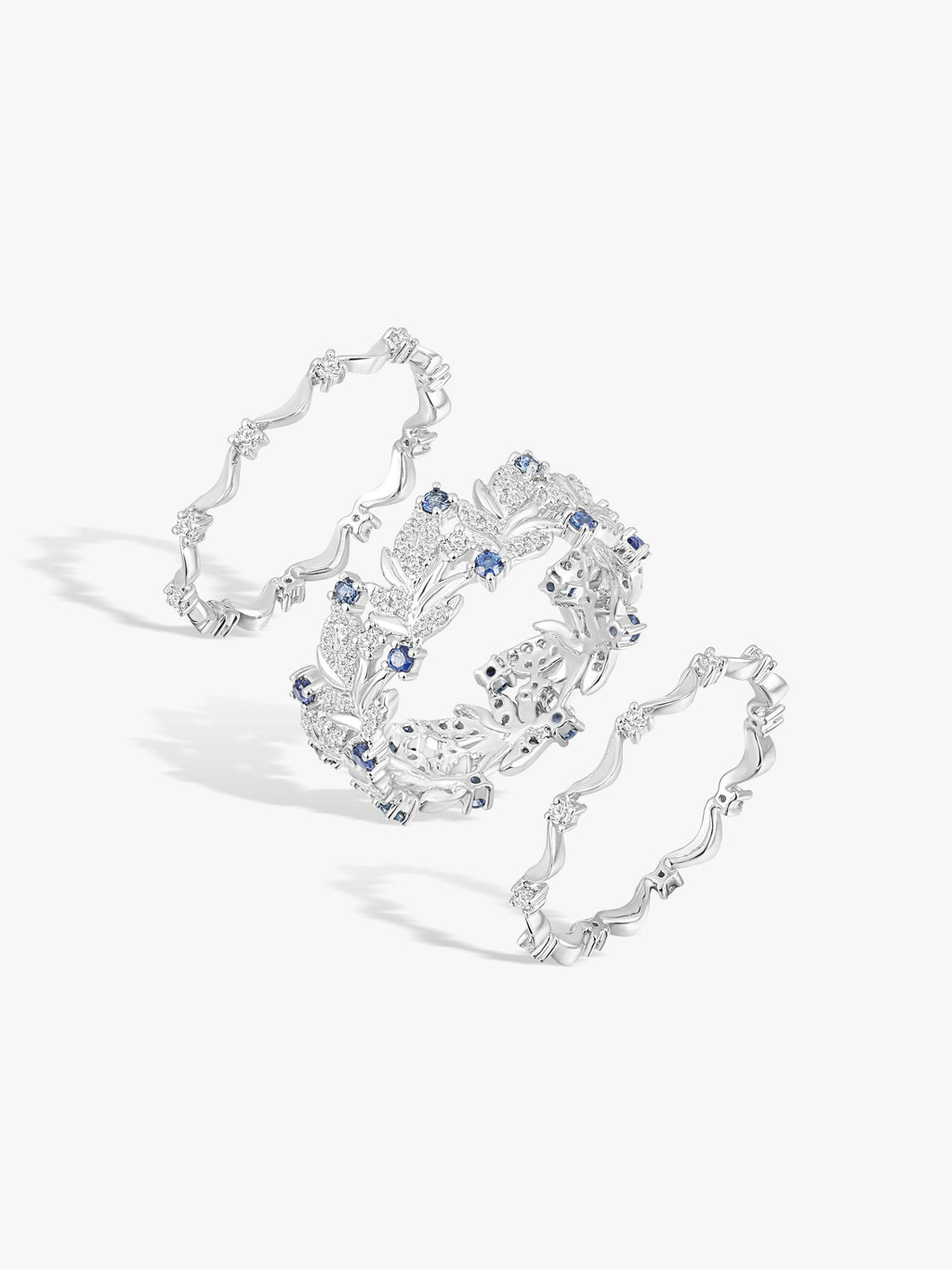 Swan-wing ring with blue sapphire-like stones and white diamond accents in openwork design