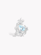 Silver-tone lily flower ring with blue gemstone center and small crystal accents