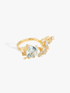 Gold aquamarine butterfly ring with oval gemstone and sparkling diamond accents