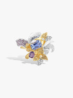 Gold iris gemstone ring with blue and purple stones, silver-toned bow leaves, square gems