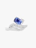 White gold ring with cushion-cut blue sapphire and diamond wave setting