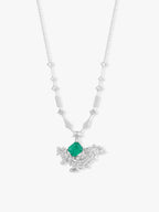Silver-tone V necklace with emerald-green cushion drop and dangling geometric accents