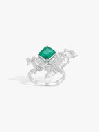 Silver-tone ring-style setting with emerald-green cushion stone and ornate side details