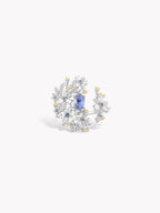 Floral branch ring with blue oval center stone and small clear and yellow accents, silver