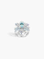 Snowflake twist ring with oval blue center stone on silver band and snowflake motifs