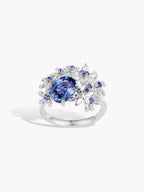 18K white gold ring with large oval blue sapphire center and side sparkles