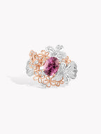18K two-tone gold ring with pink oval center sapphire and diamond halo, floral motifs