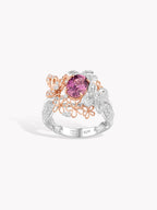 18K two-tone gold ring with pink oval center sapphire, diamond accents and floral filigree