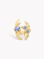 Gold-tone laurel leaf ring with round blue stones and star-like light-blue clusters