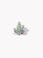 Oval purple cactus gemstone ring with green stones and clear sparkle accents