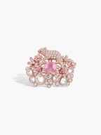 Rose gold pink gemstone halo ring with pavé round clear stones