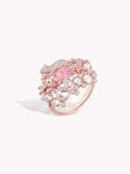 Rose gold ring featuring a pink oval center stone and sparkling round stones