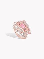 Pink gemstone cluster ring in rose gold with round halo and pavé sides