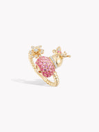 Gold-tone gourd fortune ring with pink textured dome and floral accents on top