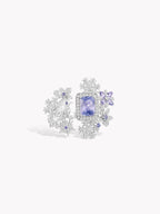 Snowflake-style ring with blue center stone and clustered icy silver details
