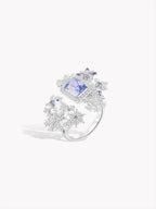 Snowflake-inspired ring, three-quarter view, square blue gemstone and halos