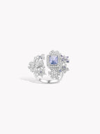 Snowflake-inspired ring with square blue gemstone and silver-toned prongs