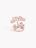 Rose gold tree-branch ring with pink oval sapphire center and clear stones