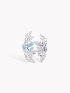 Silver laurel leaf ring with oval aquamarine center stone and small blue accents