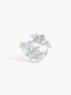 Silver laurel leaf ring with oval aquamarine stone and blue cluster detail on band