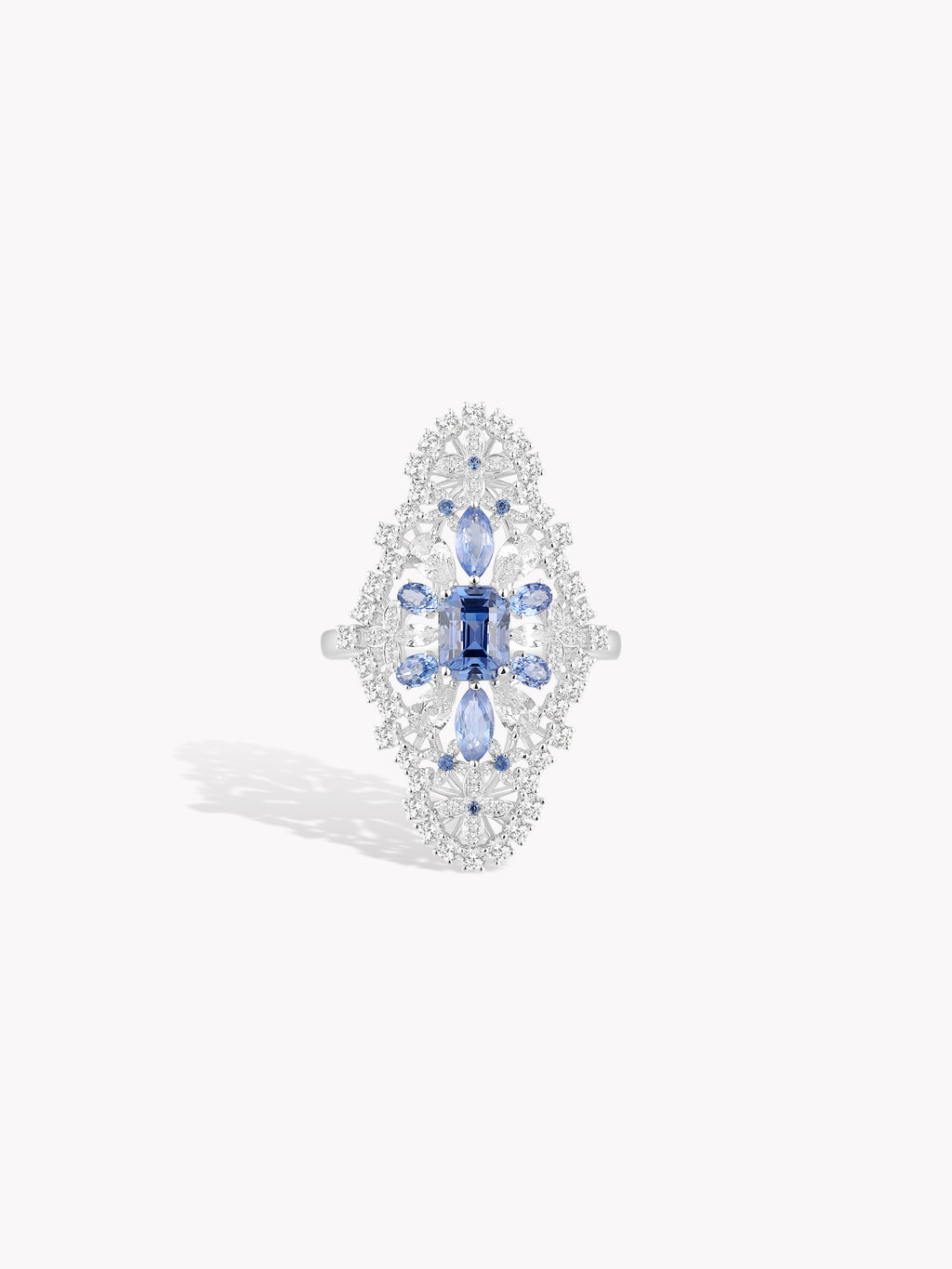 Hydrangea-style blue gemstone ring with cushion center and prong-set clear stones