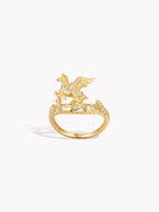 Gold-tone pegasus ring with blue stone accents and sparkling details