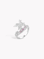 Silver-tone pegasus motif ring, side view, with clear stones and pink accents