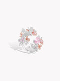 Sterling silver ring with pink center oval gemstone and clustered floral, bird-like details