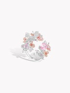 Sterling silver ring with pink center oval gemstone and clustered floral, bird-like details