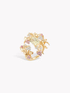 Gold-tone openwork strawberry ring with multiple clear stones and pink accents