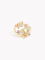 Gold-tone strawberry cluster ring with clear and pink/purple gemstones, openwork setting