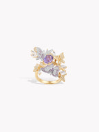 Gold-tone butterfly ring with oval purple center stone and crystal-like pavé wings