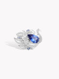 Swan sapphire ring with oval blue center stone and sparkling pave crystal accents
